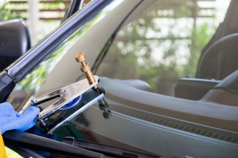 Auto glass technician at work near San Jose